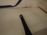 a black strap on the seat of a white car