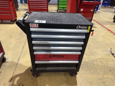a close up of a tool cart in a garage with other tools