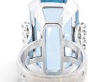 an image of a ring with a blue topaz stone and diamonds