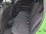 a green car with two seats in it and the door open