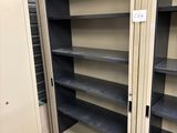 a metal cabinet with shelves in the middle of the room