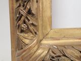 an image of a gold frame with leaves and flowers on it