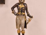 an image of a statue of a man with a hat and a sword