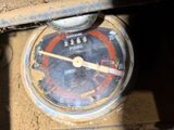 a close up of a gauge on the side of a building