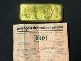 a piece of paper with a piece of gold on it