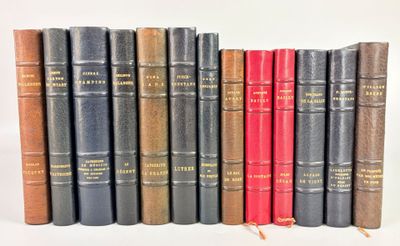several old books are lined up in a row on a white surface