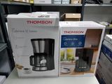 two boxes of coffee makers sitting on a table