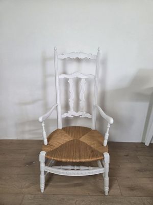 a white chair with a wooden seat on a wooden floor