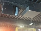 two speakers hanging from the ceiling of a building