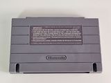 an old nintendo game console sitting on top of a white table