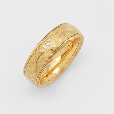a close up of a gold ring with a diamond in the center