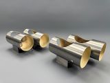 a pair of silver metal pipes on a gray surface