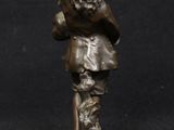 bronze figurine of a man with a hat and a cane