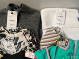 a lot of clothes and a hat on a shelf