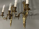 a gold colored chandelier with five lights hanging from it