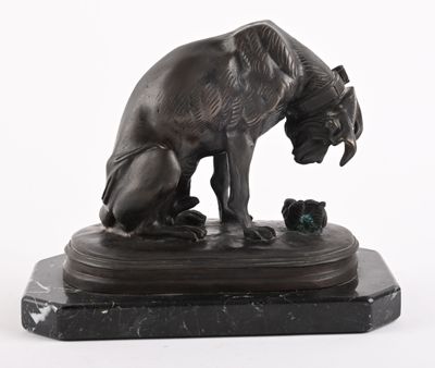 a bronze statue of a dog and a cat on a marble base