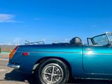 an image of a blue convertible car parked in a parking lot