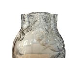 a clear glass vase with a leaf design on it