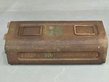 an old, rusted metal box sitting on top of a white surface