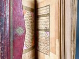 an old book opened to reveal a page of a manuscript