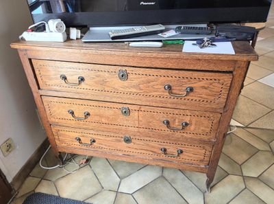 a television on top of a dresser in a living room