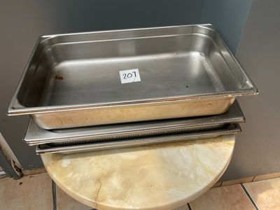 a metal pan sitting on top of a table on a tile floor