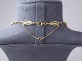 a close up of a mannequin with a gold chain on it