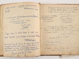 an old book with writing on it sitting on top of a table