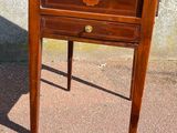 a small wooden table with a drawer on top of it