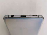 a close up of the back of a silver cell phone