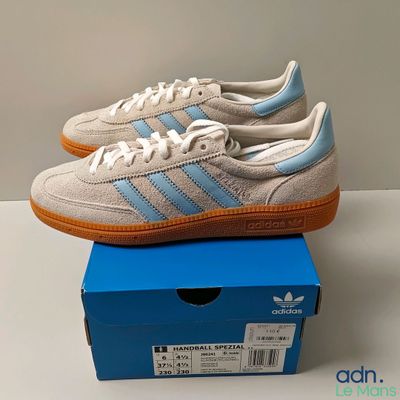 the adidas sneakers are in a box on a table