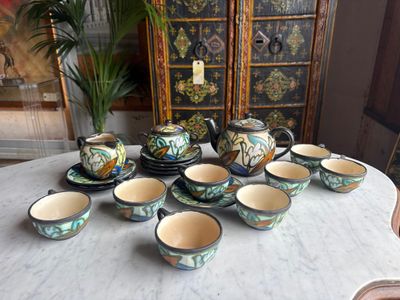 many cups and saucers sitting on a table