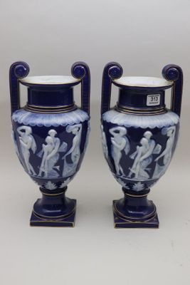 pair of blue and white vases sitting on top of a table