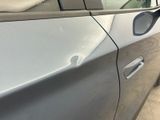 a close up of a car door handle with a hole in it