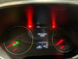 a close up of the dashboard of a car with red lights