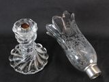 pair of clear glass candlestick holders on a black background