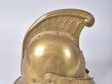 a close up of a golden helmet on a white surface