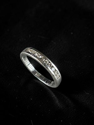 a close up of a diamond ring on a black cloth