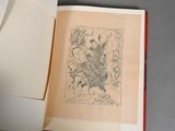 an open book with a drawing on it sitting on a table