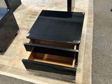a black table with two drawers on top of it