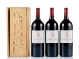 three bottles of red wine and a wooden box on a white surface