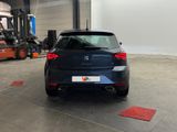 the rear end of a blue car parked in a garage