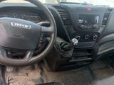 a dashboard of a vehicle with a steering wheel and dashboard controls