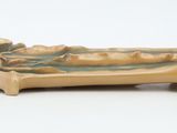 a figurine of a man in a boat on a white surface