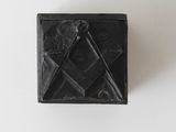 an image of a black box with a square and compass on it
