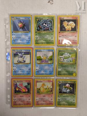 a lot of pokemon cards on display on the wall