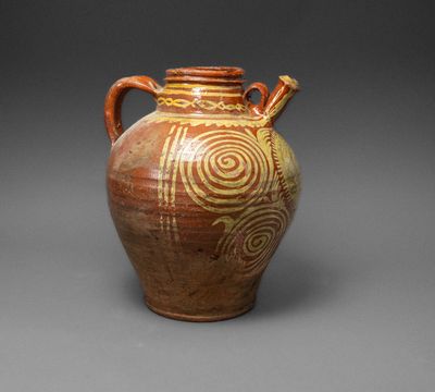 an old brown vase with a spiral design on it