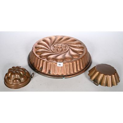 an image of a cake pan and two molds sitting on a table