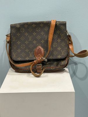 louis vuitton crossbody bag on display in a museum