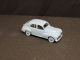 a toy car that is sitting on a brown surface